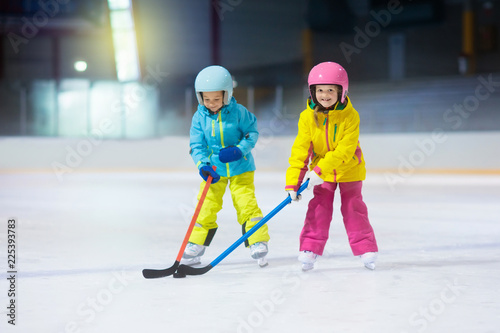 Children play ice hockey. Kids winter sport.