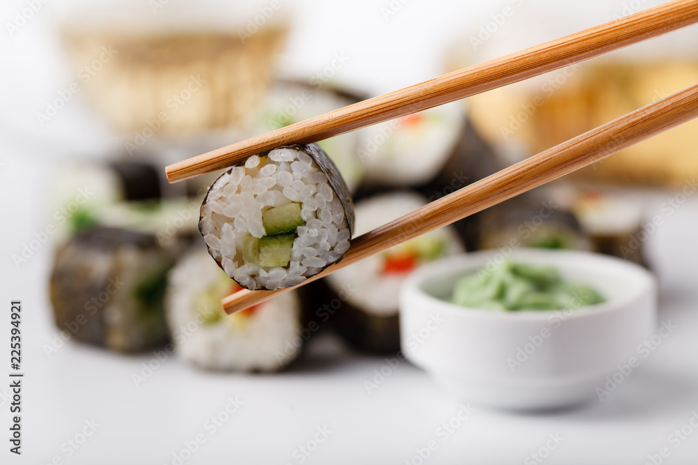 Tasty appetizing multicolored sushi rolls set, served with soy sauce and chopsticks Tasty appetizing multicolored sushi rolls set, served with soy sauce and chopsticks