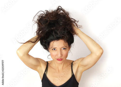 Disheveled attractive young woman on white background