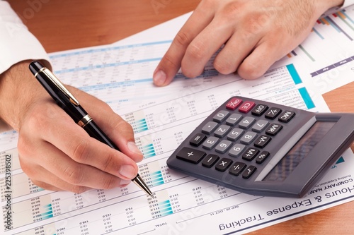 Close-up of a Businessman Analyzing Financial Figures with
