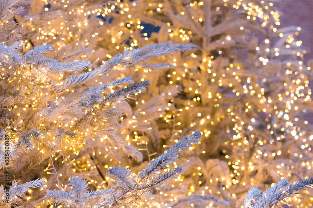 Silver Christmas tree with golden shining garlands, Christmas background Silver Christmas tree with golden shining garlands, Christmas background