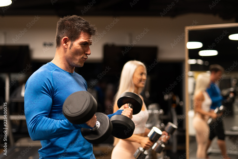 Man and woman working out in gym Man and woman working out in gym