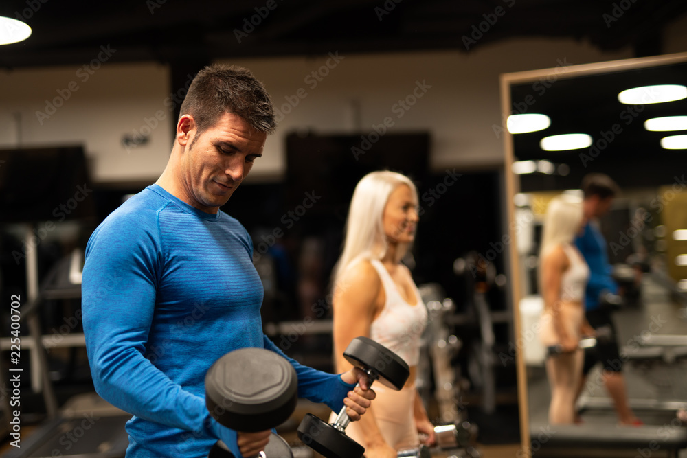 Man and woman working out in gym Man and woman working out in gym