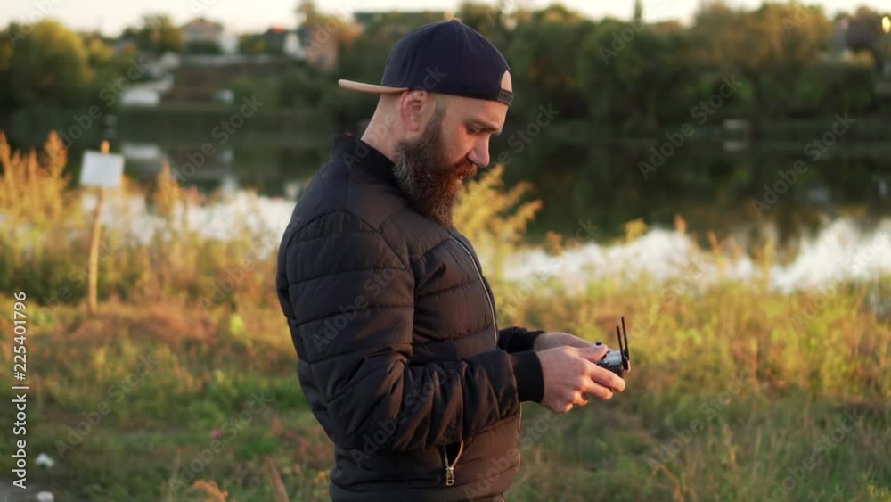 man controls drone using remote and looks up man controls drone using remote and looks up