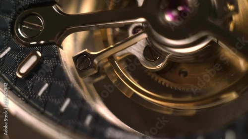 Mechanism of a watch with jewels. Open clockwork and fragments of shiny gears. Close up 4k macro shot. Time and work concept.
