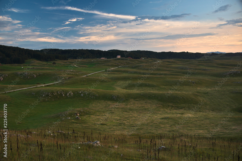 Overlooking a wavy terrain during the golden hour of sunset in the northern part of Montenegro near the Trsa village. Overlooking a wavy terrain during the golden hour of sunset in the northern part of Montenegro near the Trsa village.