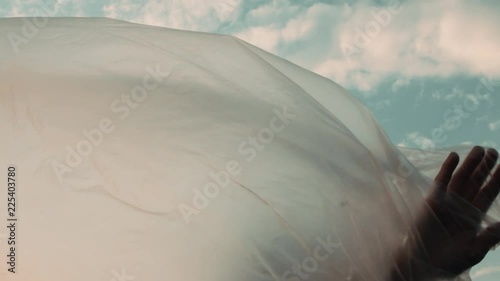 Slow Motion Shot Of A Female Experiencing Her Plastic Foil Boundaries And Disappearing