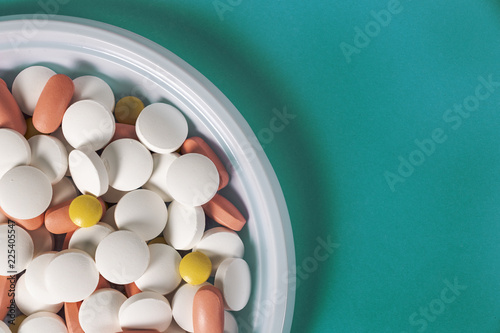 pills in a plate instead of food on a blue background