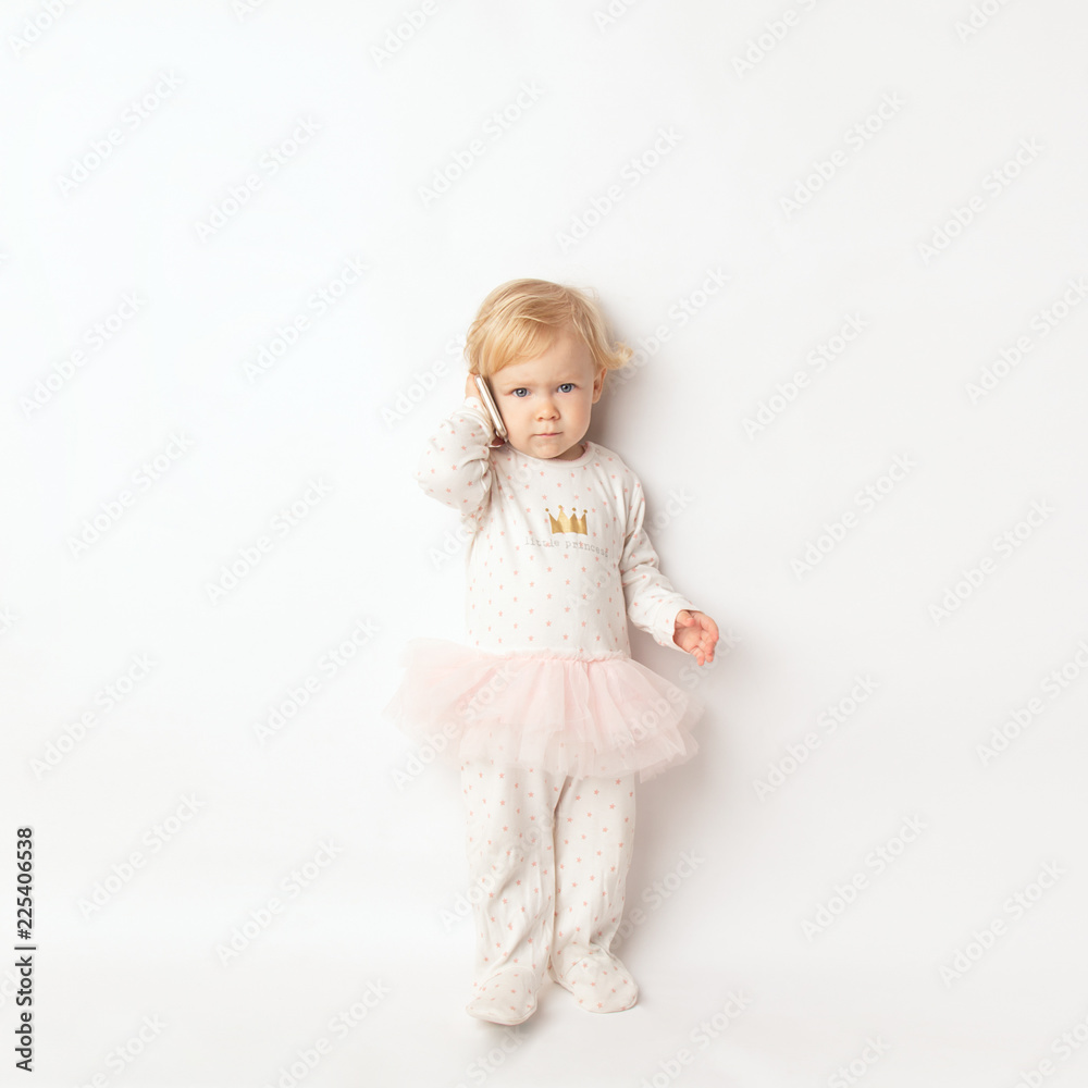 Little blond Girl with Mobile Phone Isolated on White Background. concept a new generation or children and technology Little blond Girl with Mobile Phone Isolated on White Background. concept a new generation or children and technology