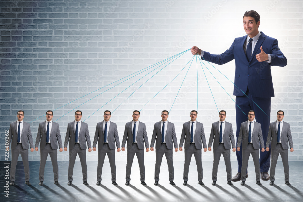 Fototapeta premium Boss employee manipulating his staff in business concept