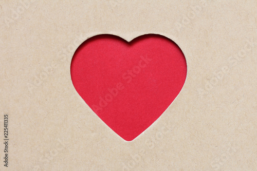 The red heart which is cut out from a cardboard