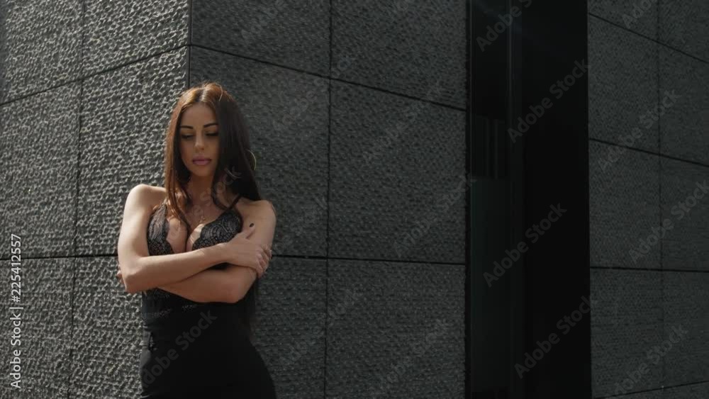 Beautiful brunette model posing in a city
