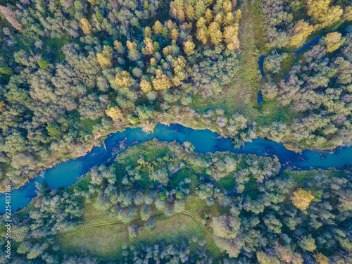 Aerial top view of autumn forest and blue river © umike_foto
