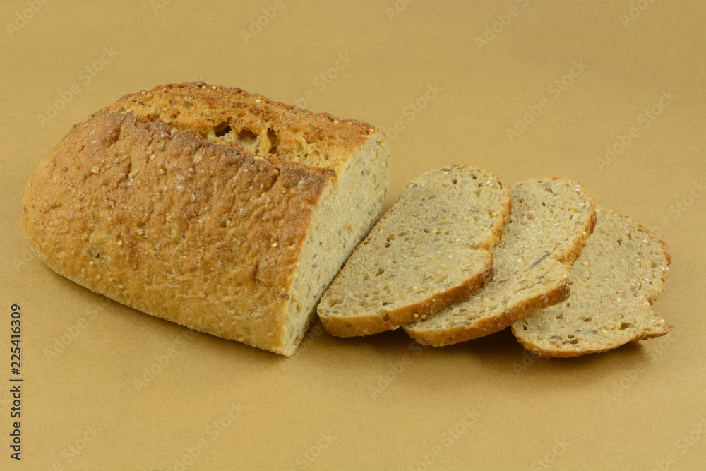Baked loaf of Focaccia bread with sesame seeds with some slices cut