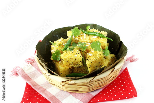 Indian gujarati Traditional Street Food Khaman Dhokla snack made from chick pea flour and rava Served With sev and Chilli  photo