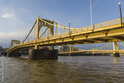 Downtown river waterfront and yellow bridges crossing the Allegheny River in Pittsburgh, Pennsylvania.