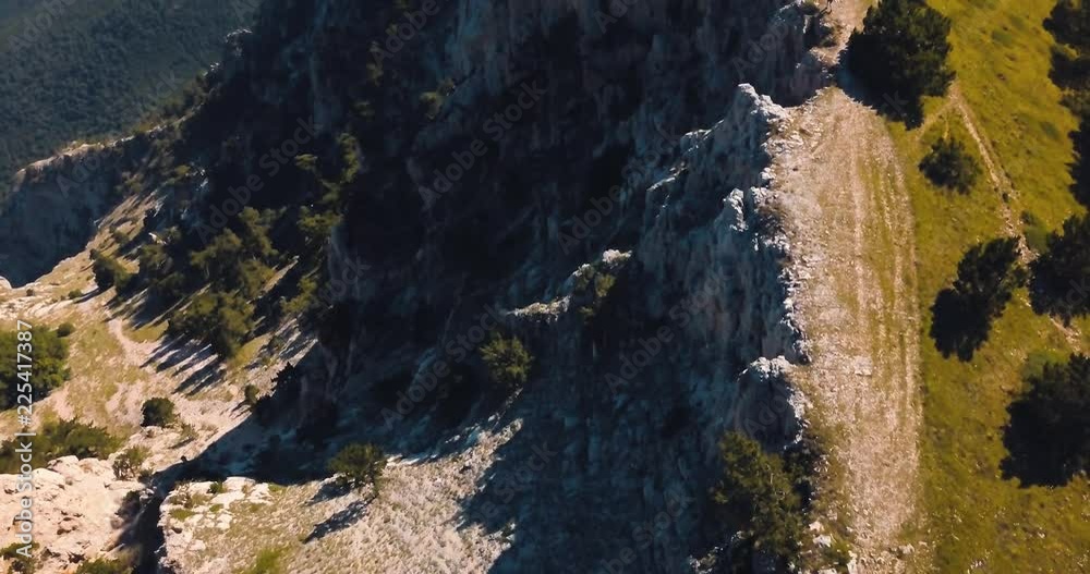 Mountains Peaks, Sunset and sea. Epic on the edge of the mountain valley with rocks and sun flare. 4k drone flight. Aerial establisher. Europe green nature. Film vintage colors. top view. Mountains Peaks, Sunset and sea. Epic on the edge of the mountain valley with rocks and sun flare. 4k drone flight. Aerial establisher. Europe green nature. Film vintage colors. top view.