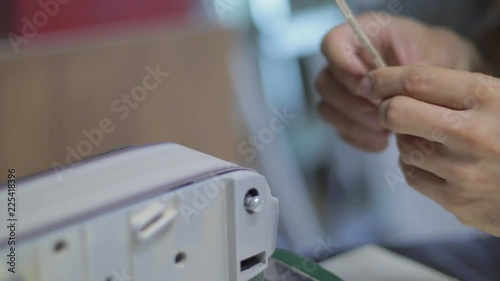 Woodworker using a power tool to achieve soft and smooth edges on the object that is been crafted. photo