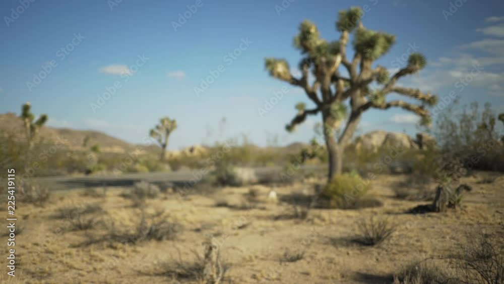 An empty highway in the distance in a large desert valley for green screen or chroma key. Out of focus or defocused shot for compositing or keying. An empty highway in the distance in a large desert valley for green screen or chroma key. Out of focus or defocused shot for compositing or keying.