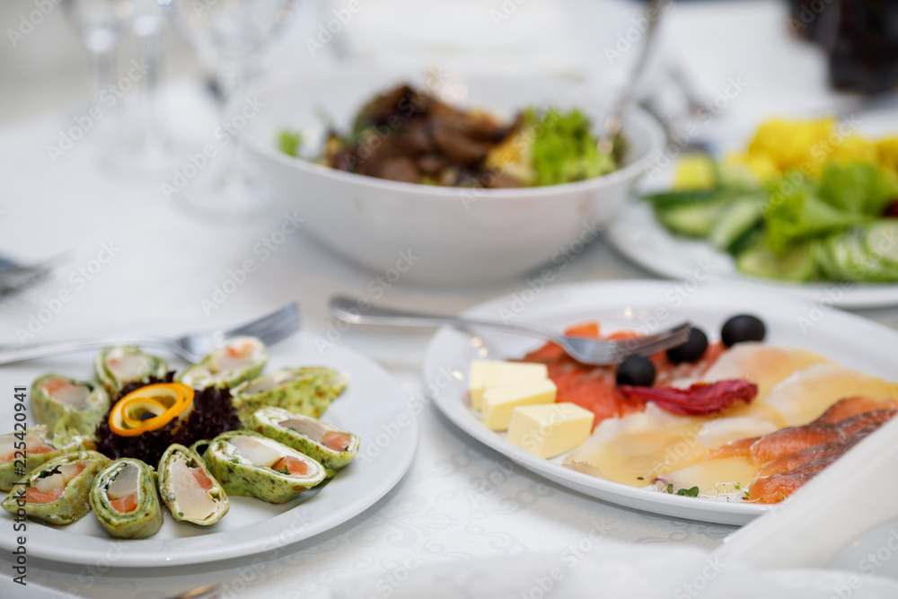 Served dishes to the table for holiday. Design a festive Banquet Served dishes to the table for holiday. Design a festive Banquet