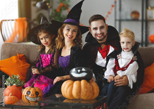 happy family mother father and children in costumes and makeup on Halloween