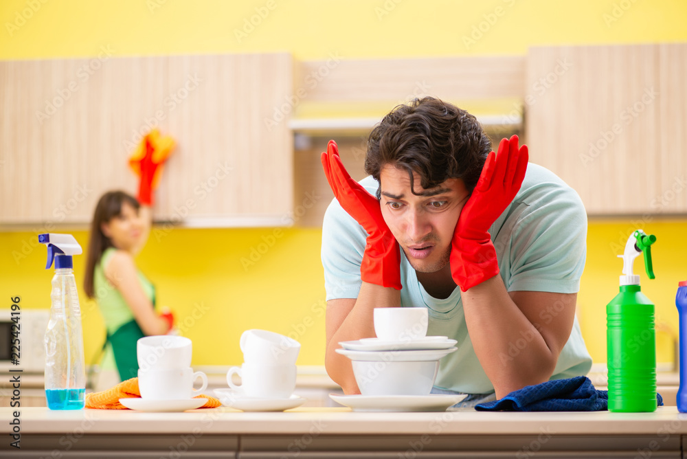 Young couple working at kitchen Young couple working at kitchen