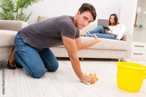 Young family doing cleaning at home