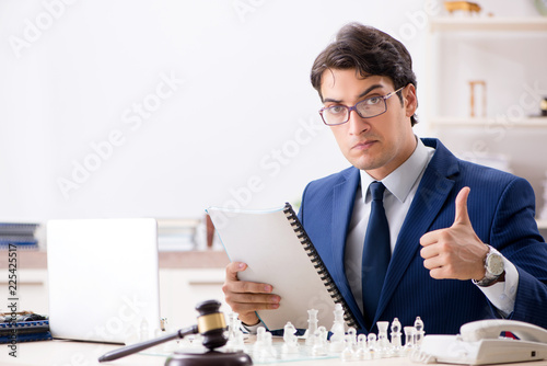 Young lawyer playing chess to train his court strategy and tacti photo