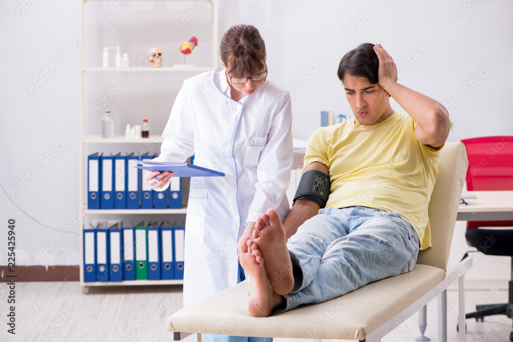 Young doctor checking patients blood pressure Young doctor checking patients blood pressure