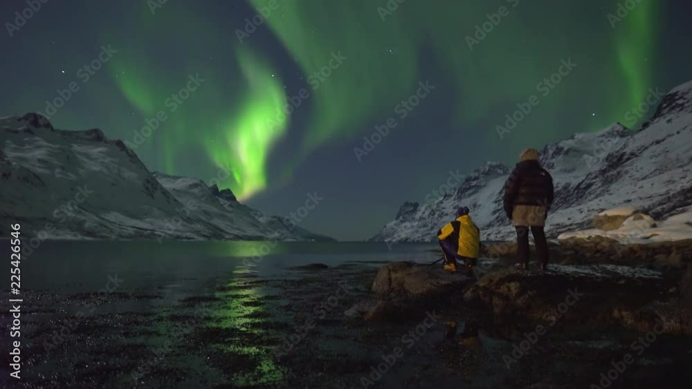 Northern Lights (Aurora Borealis) filmed in real time. Two tourists ...