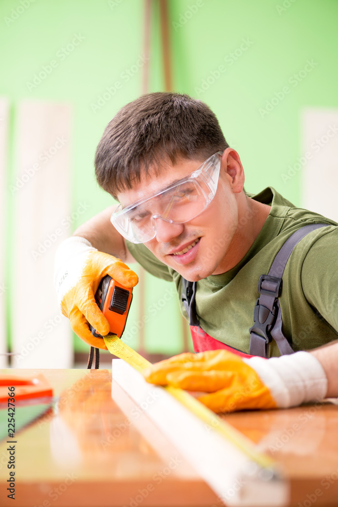 Young man carpenter working in workshop Young man carpenter working in workshop