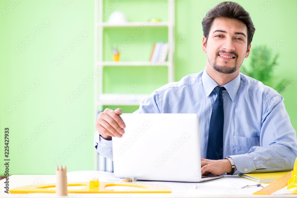 Young male architect working at the project Young male architect working at the project