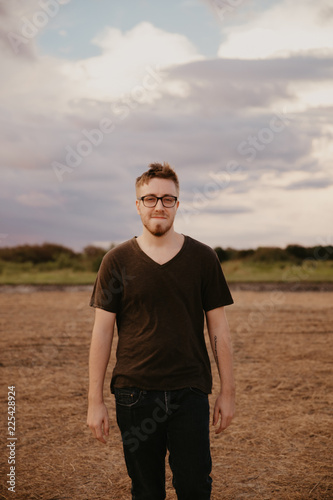 Handsome Young Male Model in Glasses and V-neck Modeling in Open Field Background
