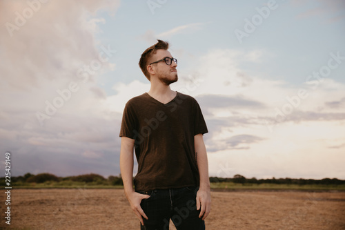 Handsome Young Male Model in Glasses and V-neck Modeling in Open Field Background © MeganMahoneyPhotos