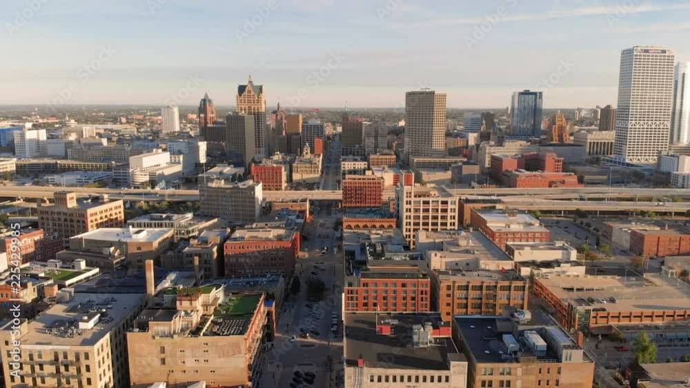 Drone flying above street in downtown. Aerial view of american city at dawn. High-rise buildings. Sunny morning. Milwaukee, Wisconsin, United States.
Drone flying above street in downtown. Aerial view of american city at dawn. High-rise buildings. Sunny morning. Milwaukee, Wisconsin, United States.