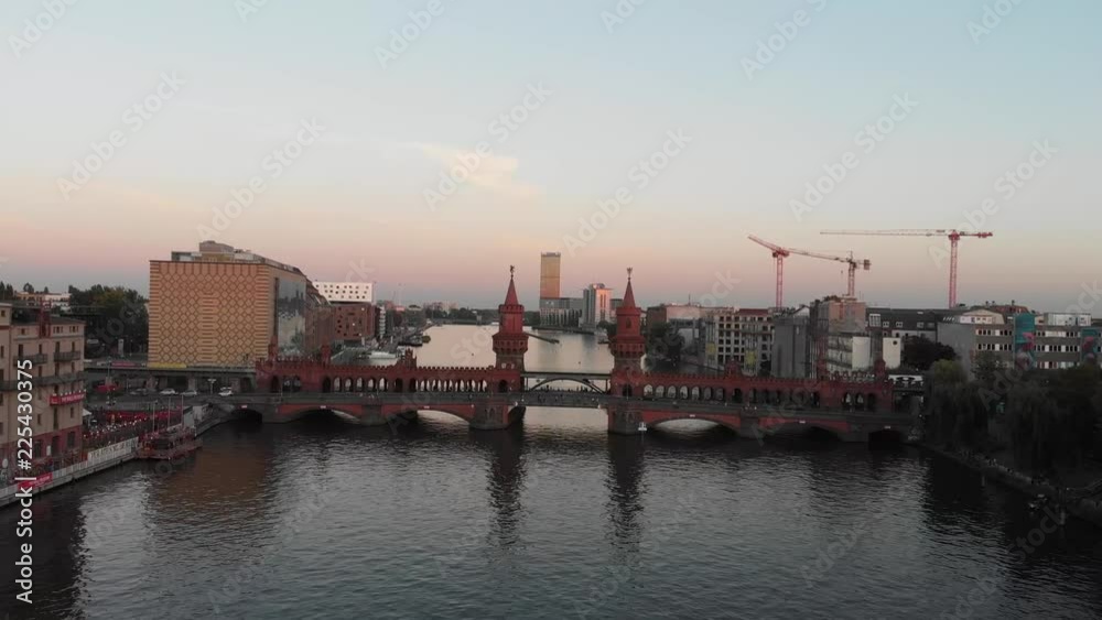 Aerial panoramic view of the Oberbaum Bridge in Berlin, Germany with drone flying over the Spree River during the sunset Aerial panoramic view of the Oberbaum Bridge in Berlin, Germany with drone flying over the Spree River during the sunset