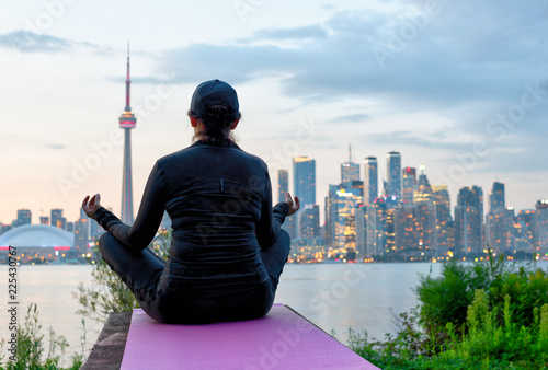 Middle-aged woman practicing yoga at the front of Toronto