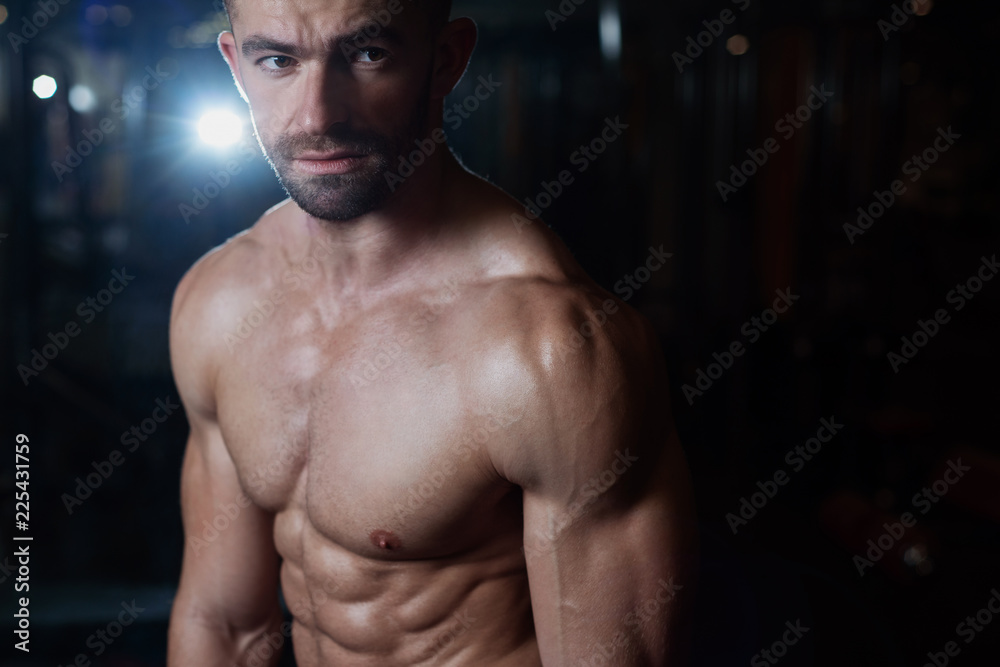 Fototapeta premium Portrait of a brutal athletic man with a muscular body. Health and fitness concept