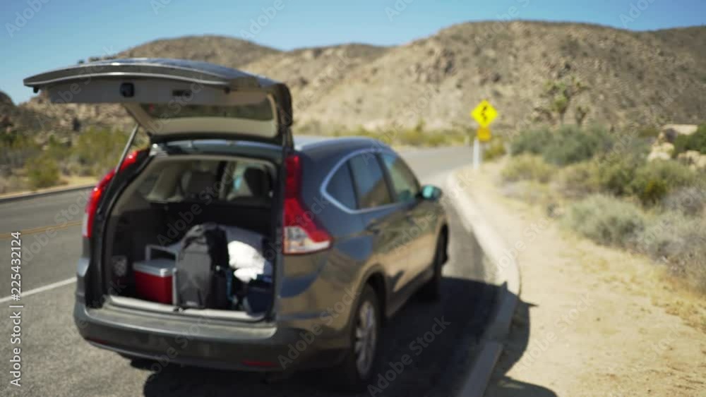 An open hatchback on the side of a desert highway for green screen or chroma key. Out of focus or defocused shot for compositing or keying. An open hatchback on the side of a desert highway for green screen or chroma key. Out of focus or defocused shot for compositing or keying.