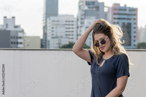 Closeup portrait, happy confident successful pretty young woman, isolated background of building, trees. Positive human emotions, facial expressions. Urban lifestyle.