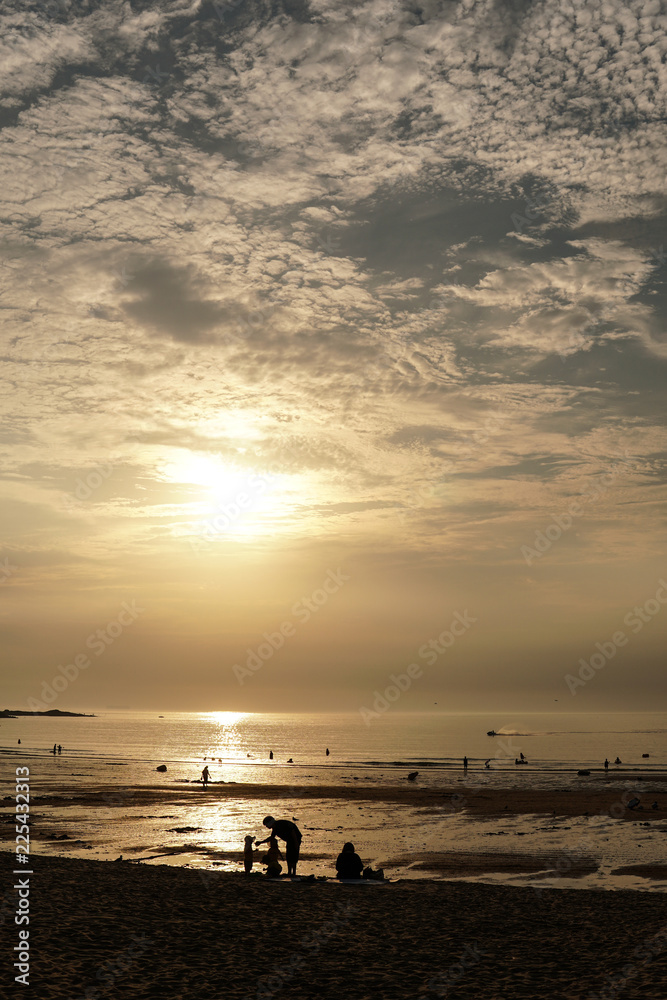 Fototapeta premium Mother and son on an evening beach