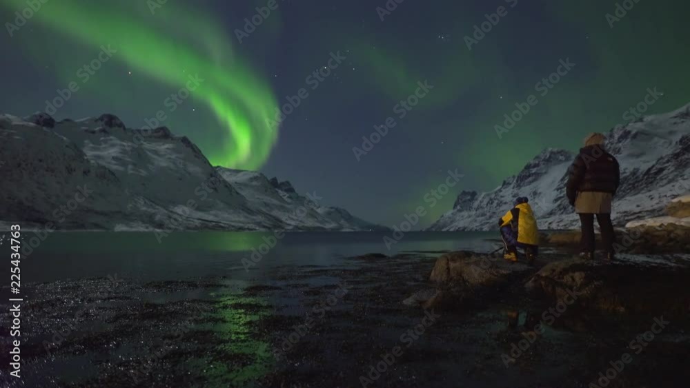 Northern Lights (Aurora Borealis) filmed in real time. Two tourists ...