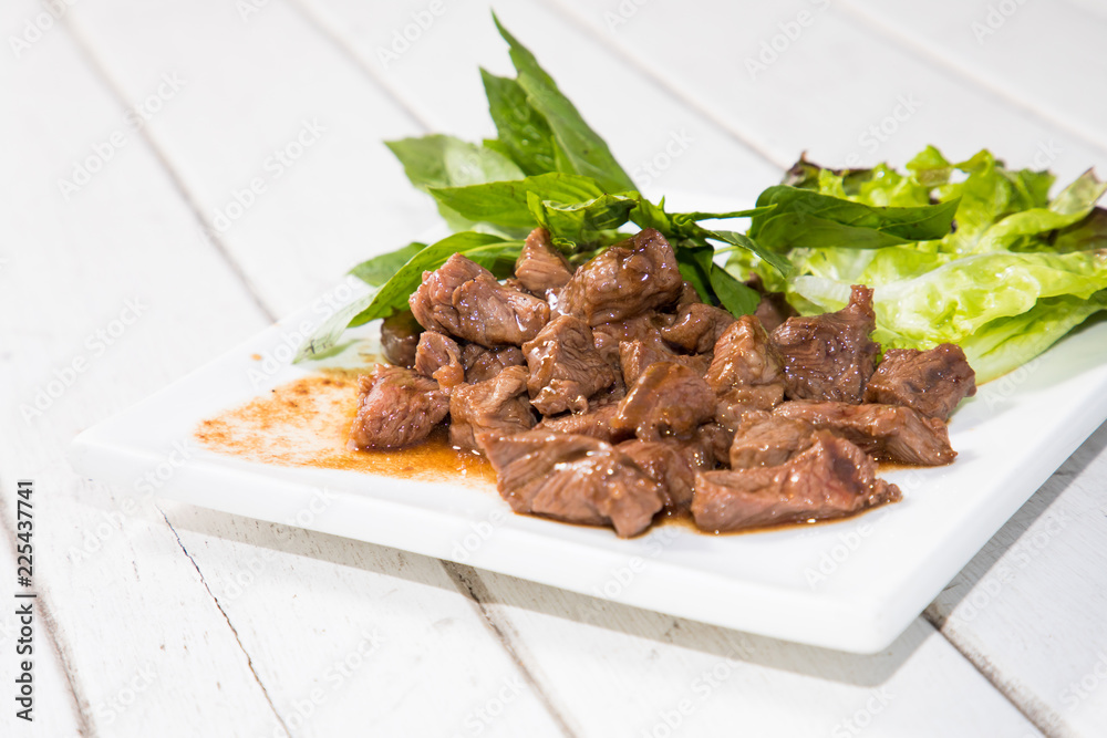 Beef stir fry with green salad on white background, Thai Food stye