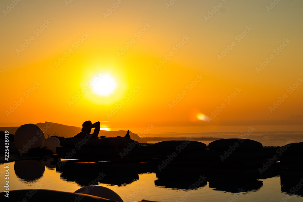 Silhouetted Man watching sunset, Santorini Greece