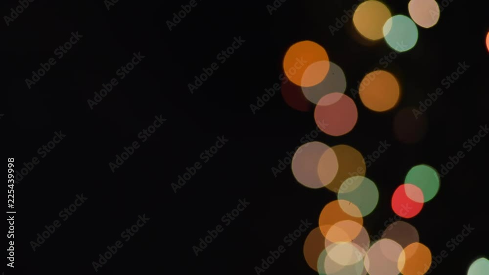 Jiggling abstract multi-colored bokeh on the right side of the frame for green screen or chroma key. Out of focus or defocused shot for compositing or keying. Jiggling abstract multi-colored bokeh on the right side of the frame for green screen or chroma key. Out of focus or defocused shot for compositing or keying.