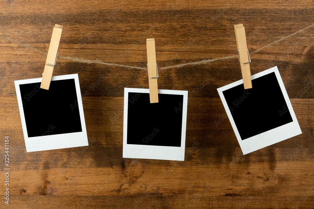 Three Blank Polaroid Frames Hanging on Twine Attached with