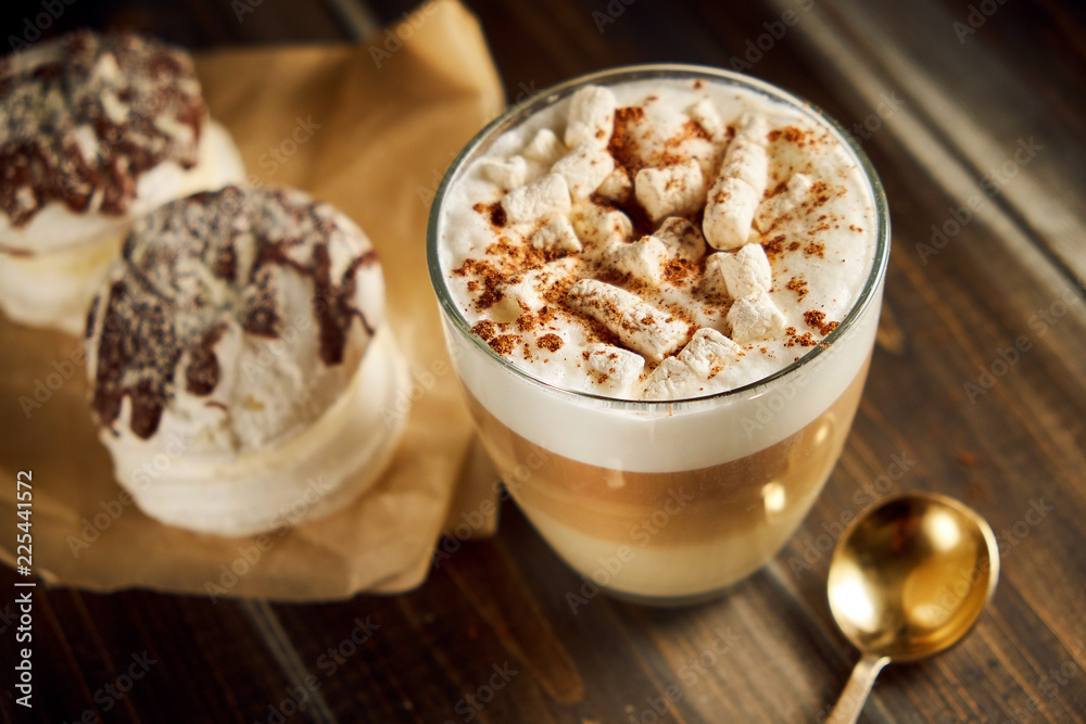 Cup of cappuccino coffee marshmallows on wooden table Cup of cappuccino coffee marshmallows on wooden table