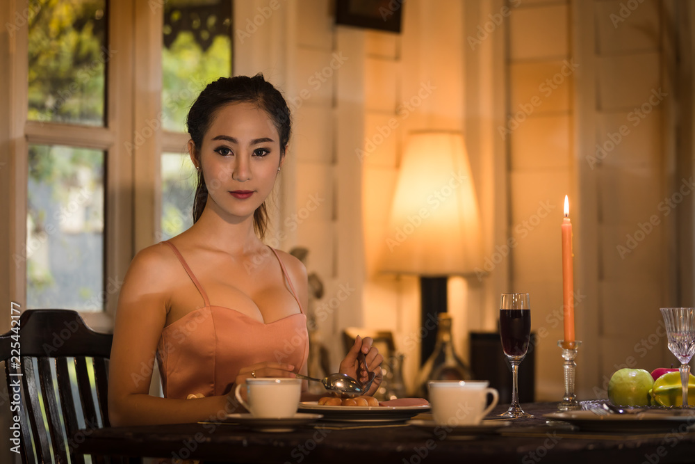 Young asian girl in evening dress dinner under candlelight to night special Young asian girl in evening dress dinner under candlelight to night special