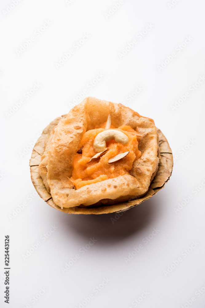 Suji/Sooji Halwa Puri or Shira Poori breakfast, served in a plate and bowl. selective focus Suji/Sooji Halwa Puri or Shira Poori breakfast, served in a plate and bowl. selective focus