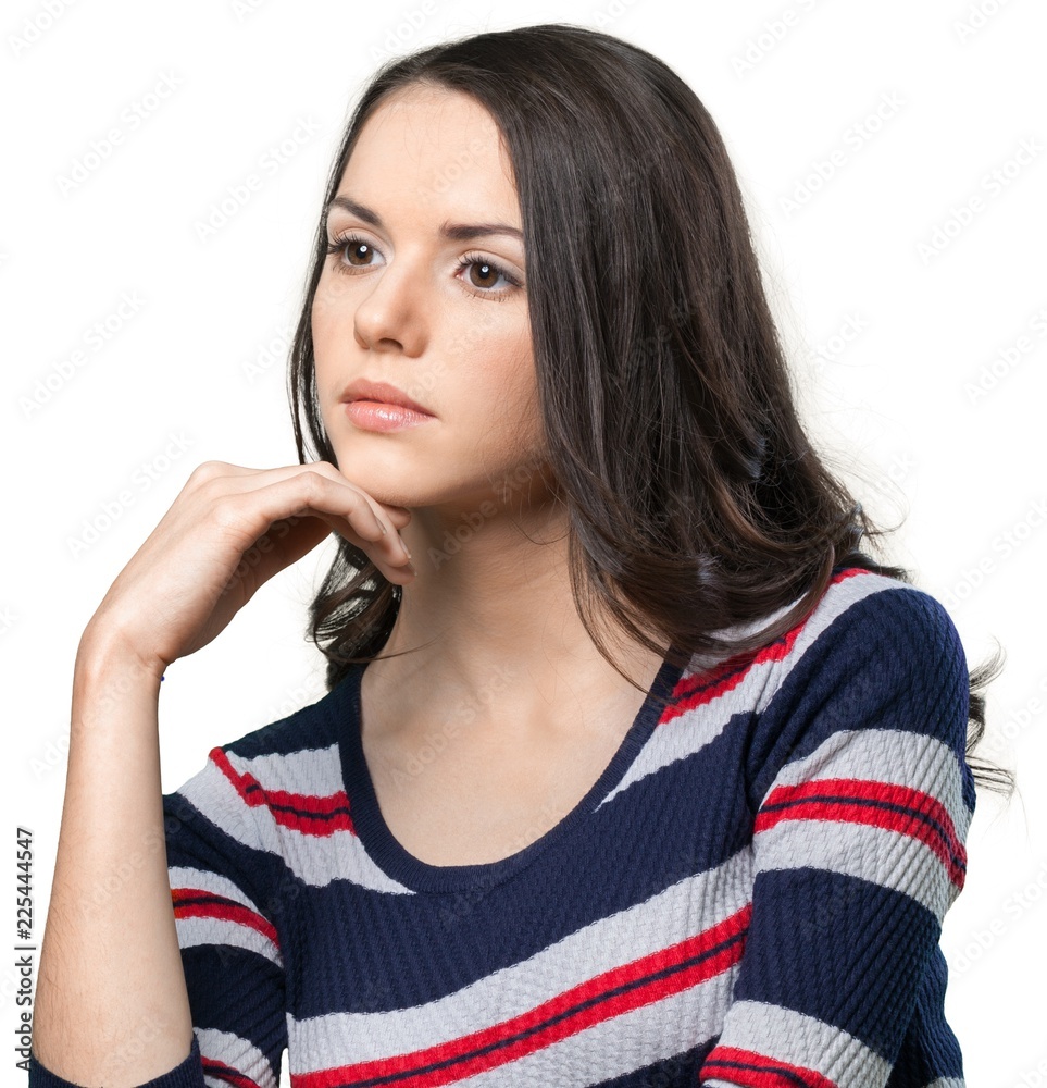Serious looking brunette with her hand resting on her chin Serious looking brunette with her hand resting on her chin